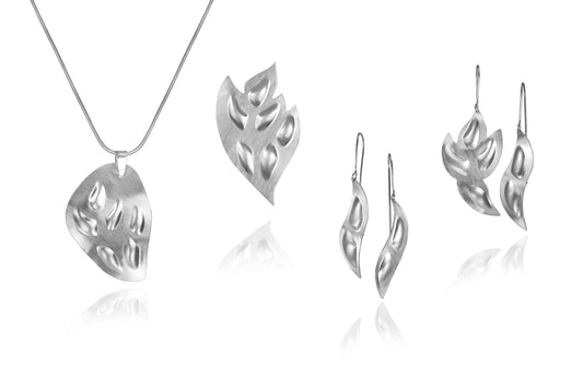 The Northern Light Series is inspired by the dance of the northern lights across the night sky and humanity's spiritual dance with "Self". The shapes represent a person dancing with the "One". The matt finish of the sterling silver piece and the whole shape captures the shimmering light of the northern lights. The pieces share an experience of spirit and aliveness.
